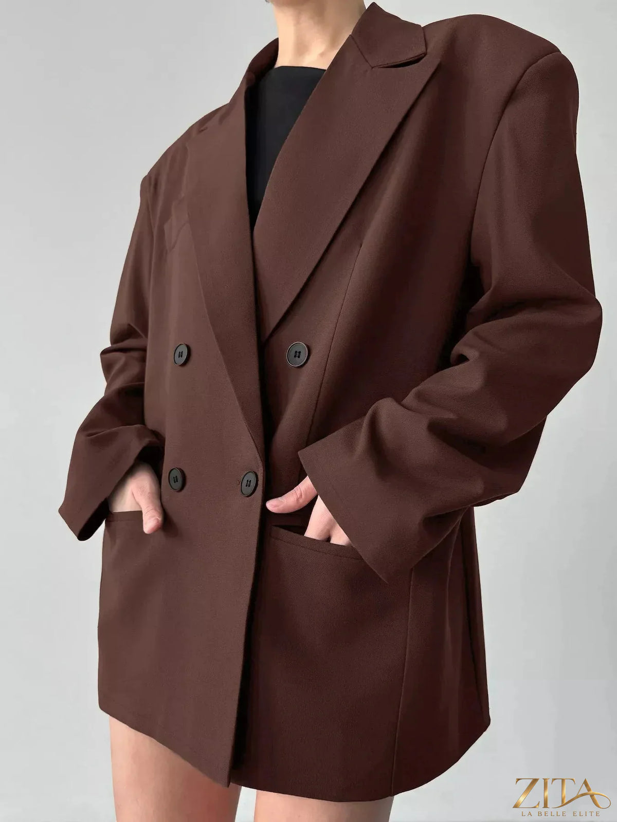 Dark gray double-breasted blazer with lapel collar from Trendsi, shown on a hanger with visible buttons and tailored fit.