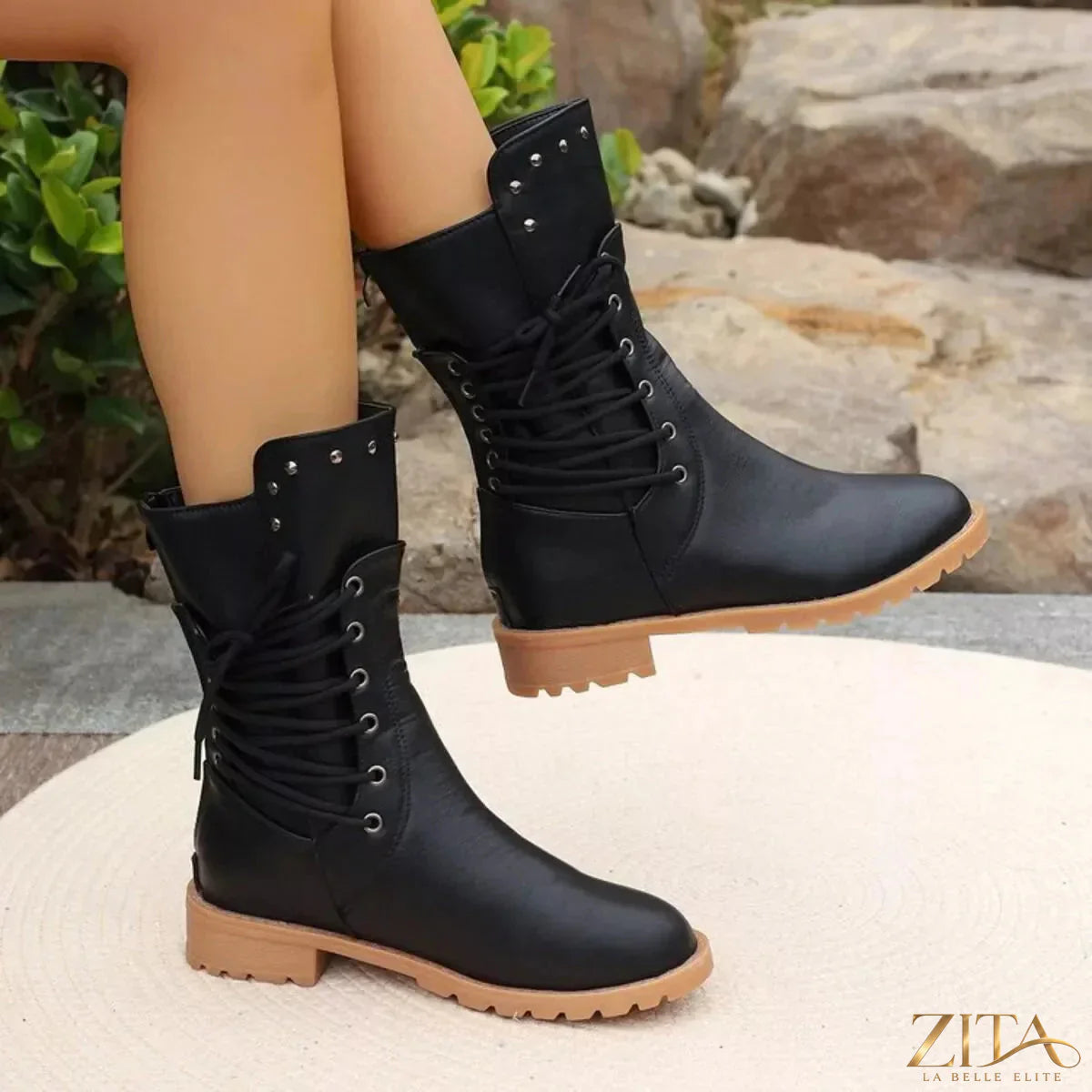 Black studded lace-up boots by Trendsi featuring silver hardware and chunky soles, styled with urban fashion.