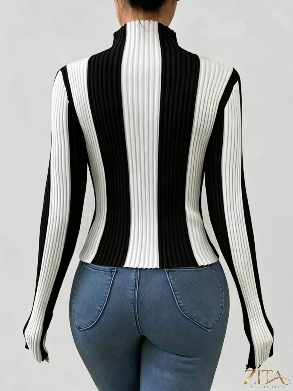 Color block turtleneck ribbed knit top by Trendsi, featuring vibrant color panels and a cozy fitted design.