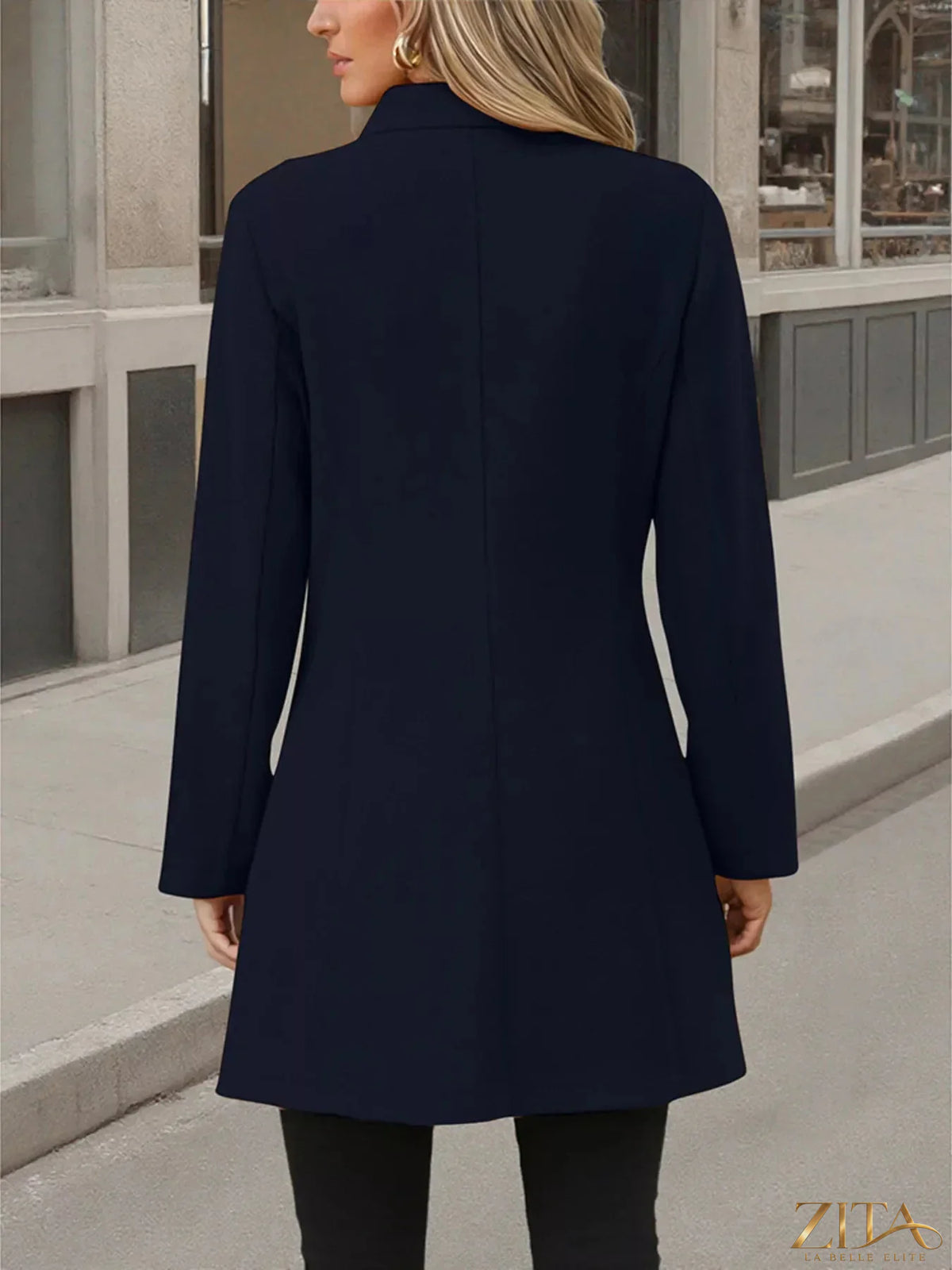 Zita La Belle Elite button-up long sleeve coat hanging on a hanger, showing its classic collar and tailored fit.