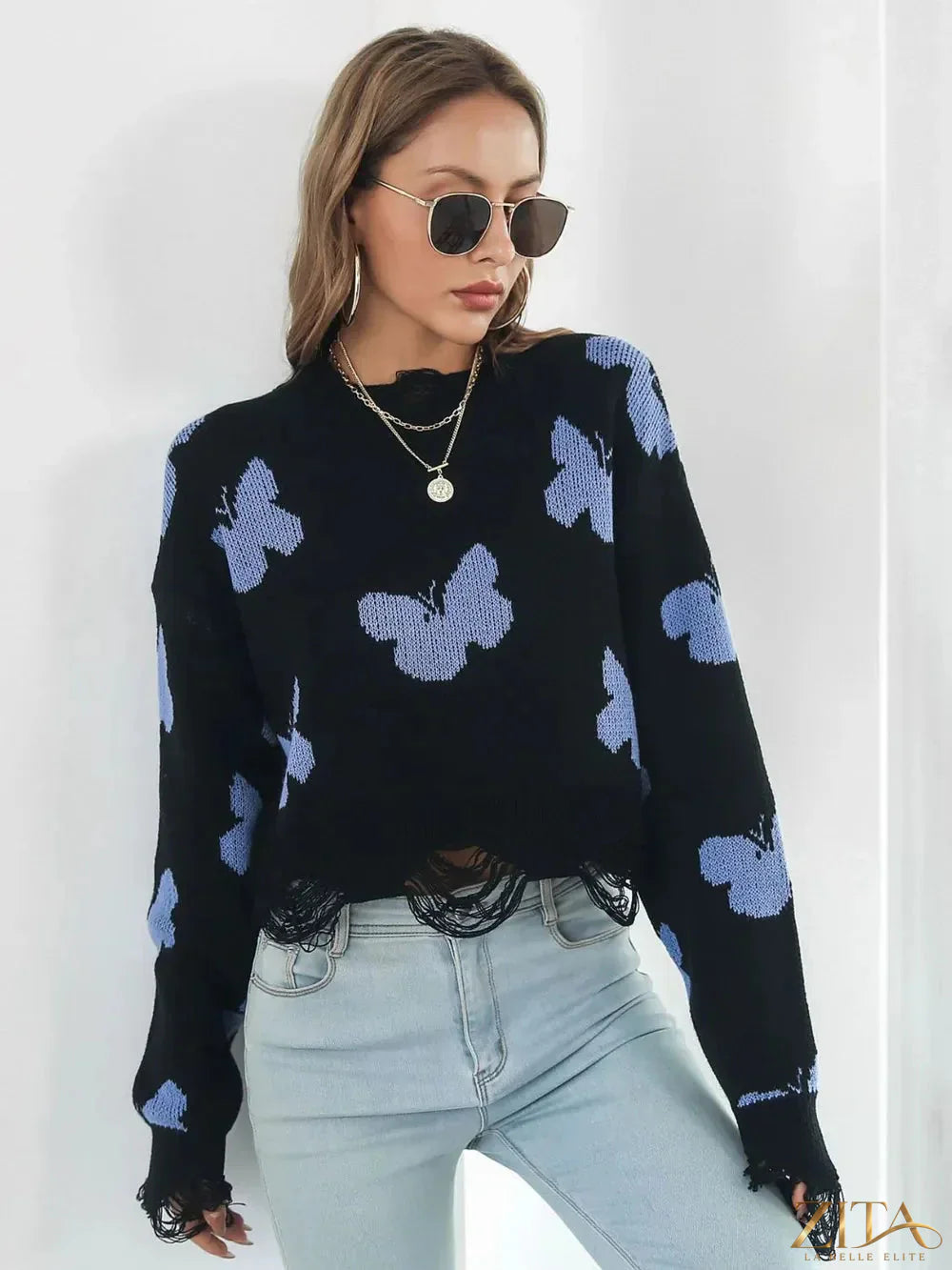 Distressed butterfly cropped sweater by Zita La Belle Elite showing a close-up of the soft, stylish knit with butterfly design and distressed details.