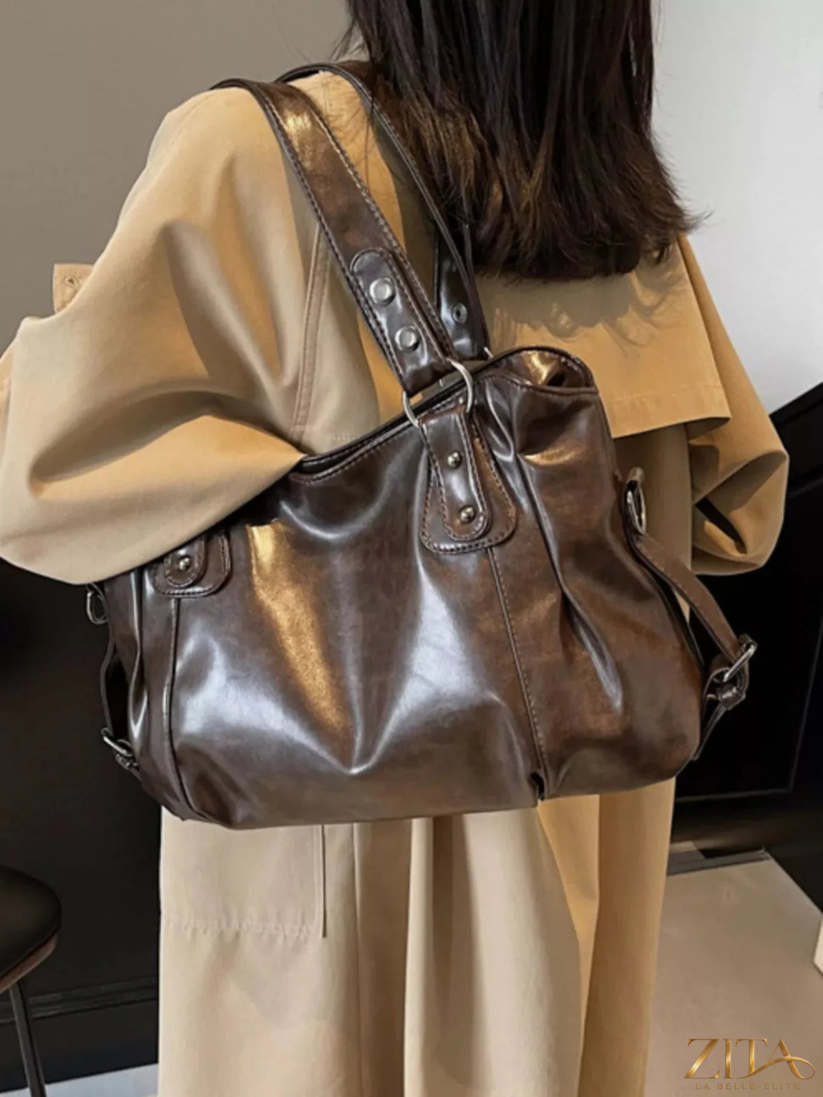 Vintage style leather handbag by Trendsi featuring a classic design, brown leather with top handles and metal accents.