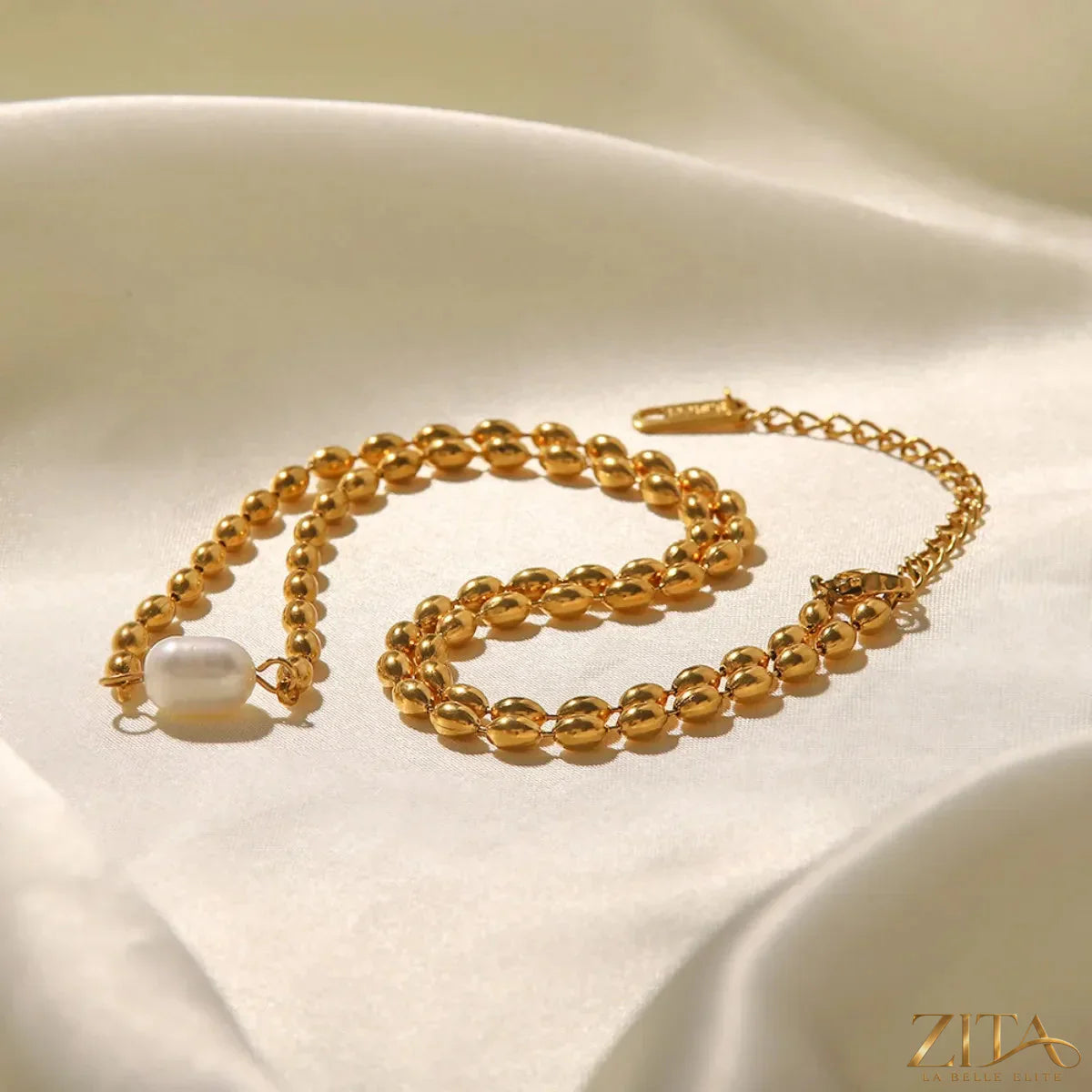 Pearl and gold chain jewelry set with matching necklace and bracelet, featuring elegant pearls and gold accents.