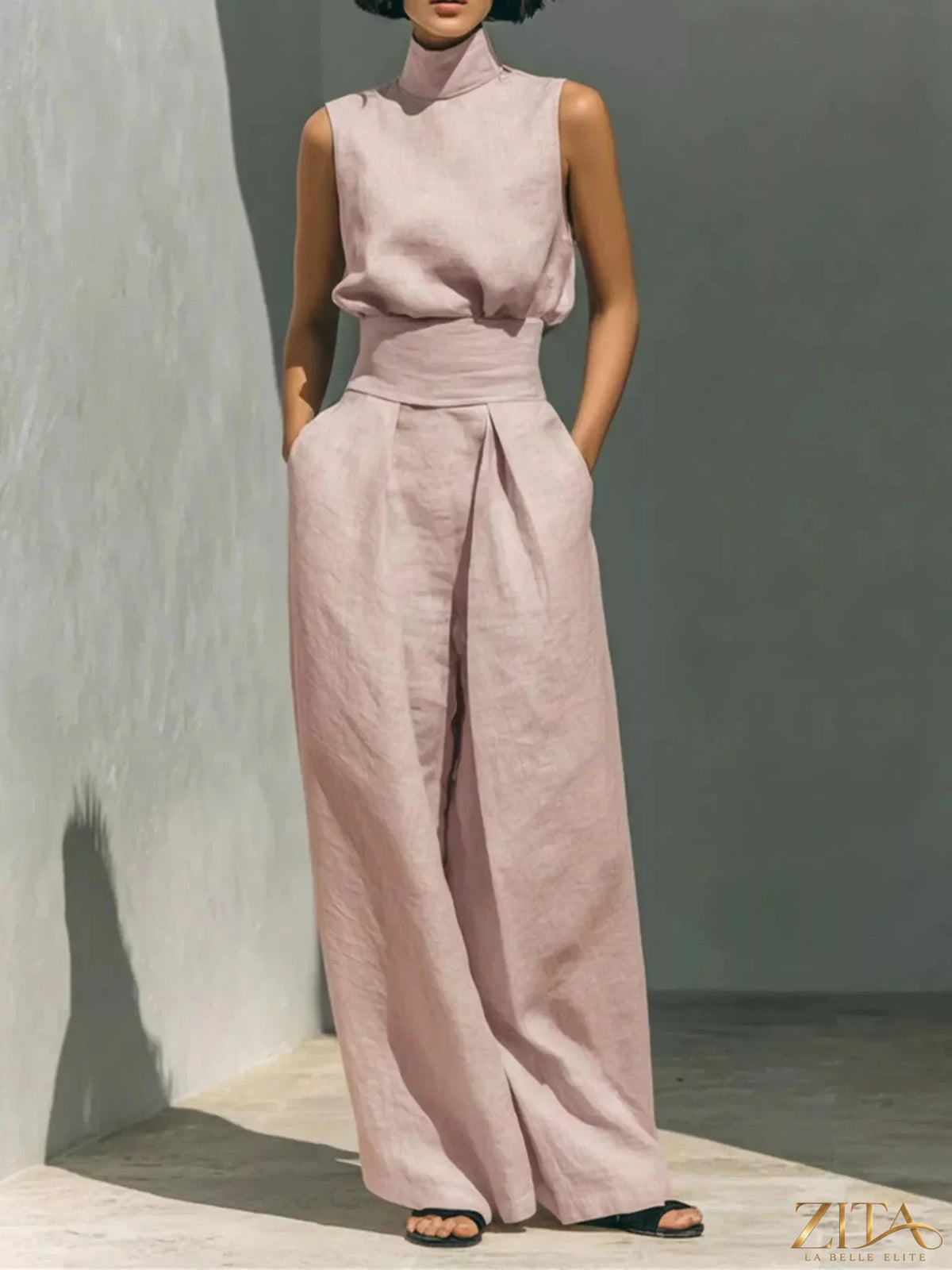 Sleeveless turtleneck top and wide-leg pants set by Trendsi, featuring a stylish, coordinated fashion ensemble.