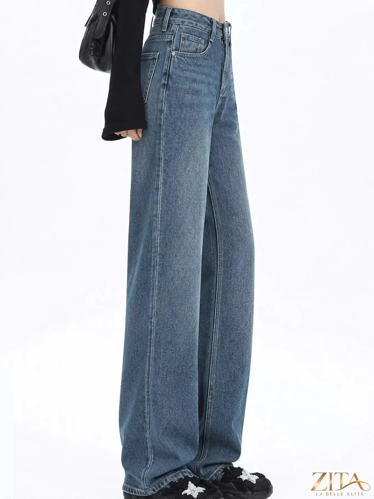 High-waisted vintage wash wide-leg jeans by Zita La Belle Elite, displayed on a hanger showcasing relaxed fit and classic denim style.