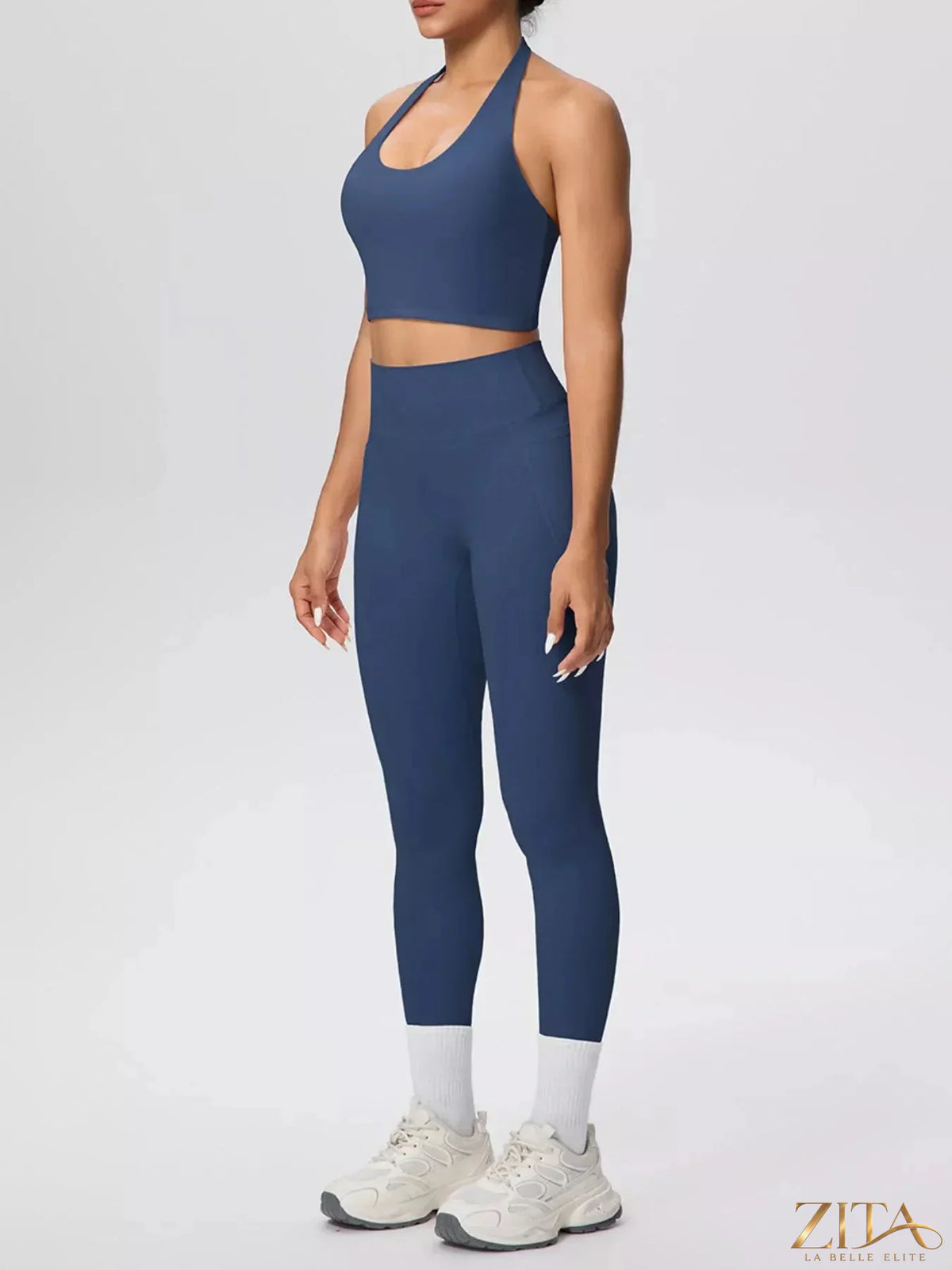 Zita La Belle Elite halter neck crop top and high-waisted leggings active set, shown in black on a model in a fitness pose.