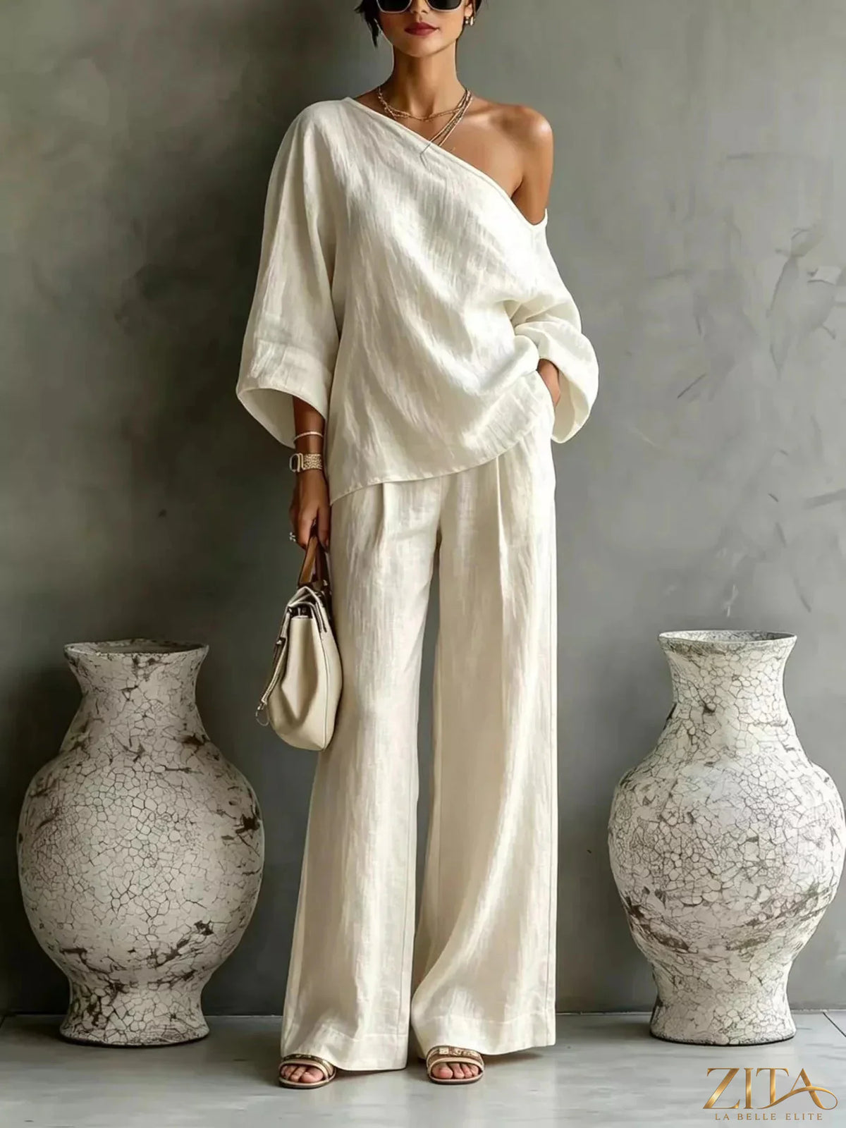 Zita La Belle Elite one-shoulder top and wide-leg pants set, stylish fashion ensemble, in a neutral color, worn by a model.