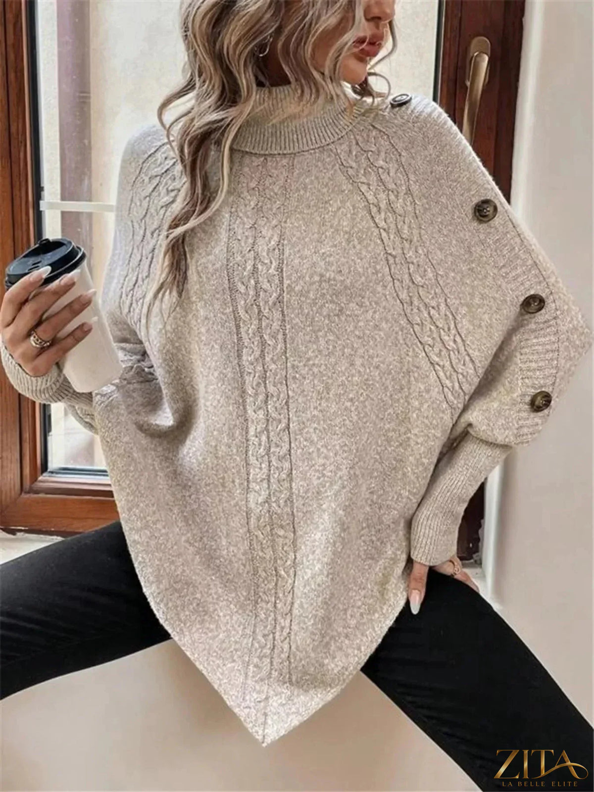 Cable knit turtleneck cape sweater from Trendsi, showcasing its cozy, textured knit fabric and stylish turtleneck design.