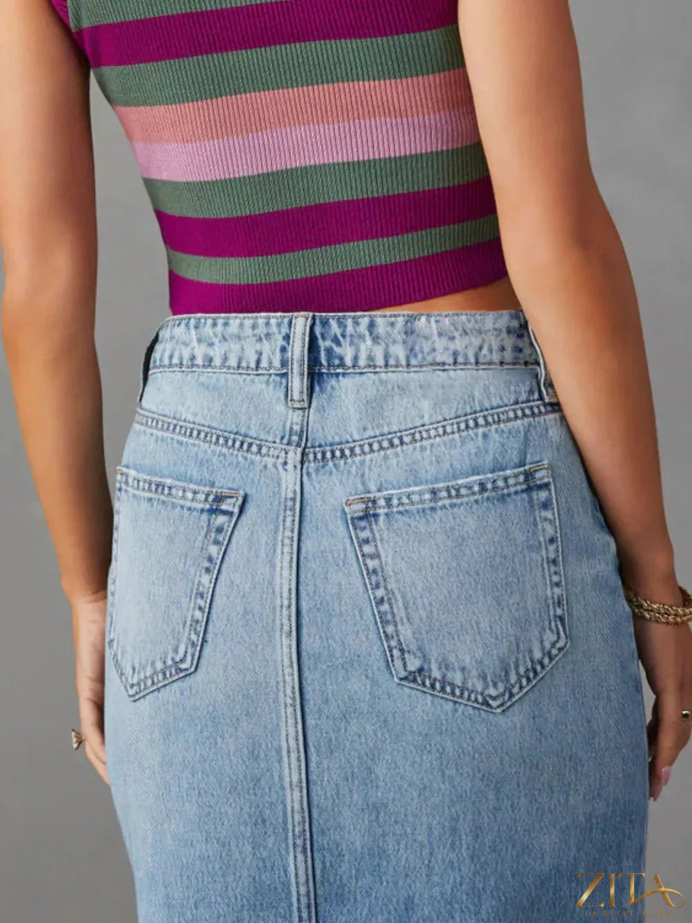 Raw hem front slit denim midi skirt by Zita La Belle Elite, showing the A-line shape, front slit, and distressed raw hem detail.