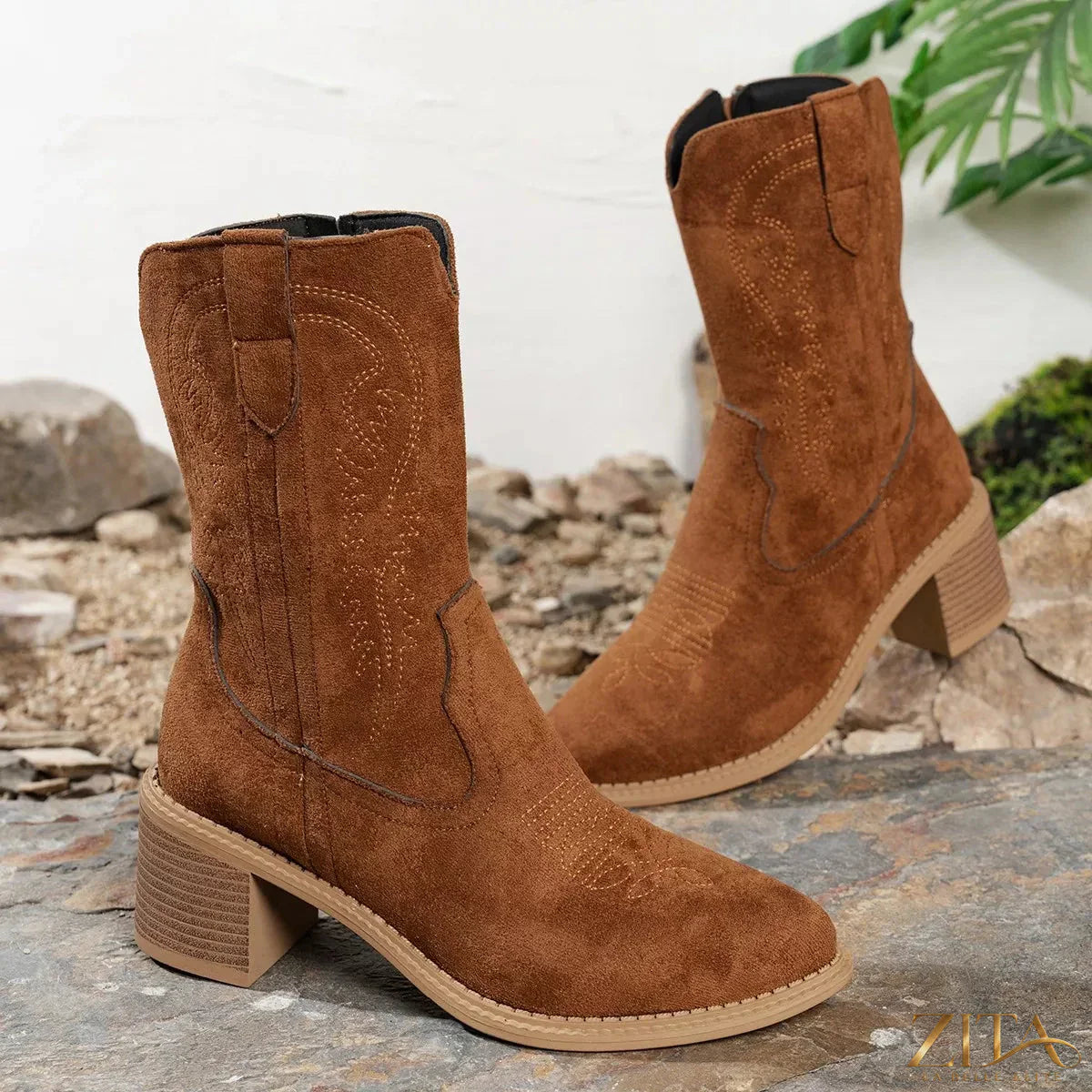 Suede block heel Western boots with pointed toes and stitching details, featuring a stylish Western silhouette.