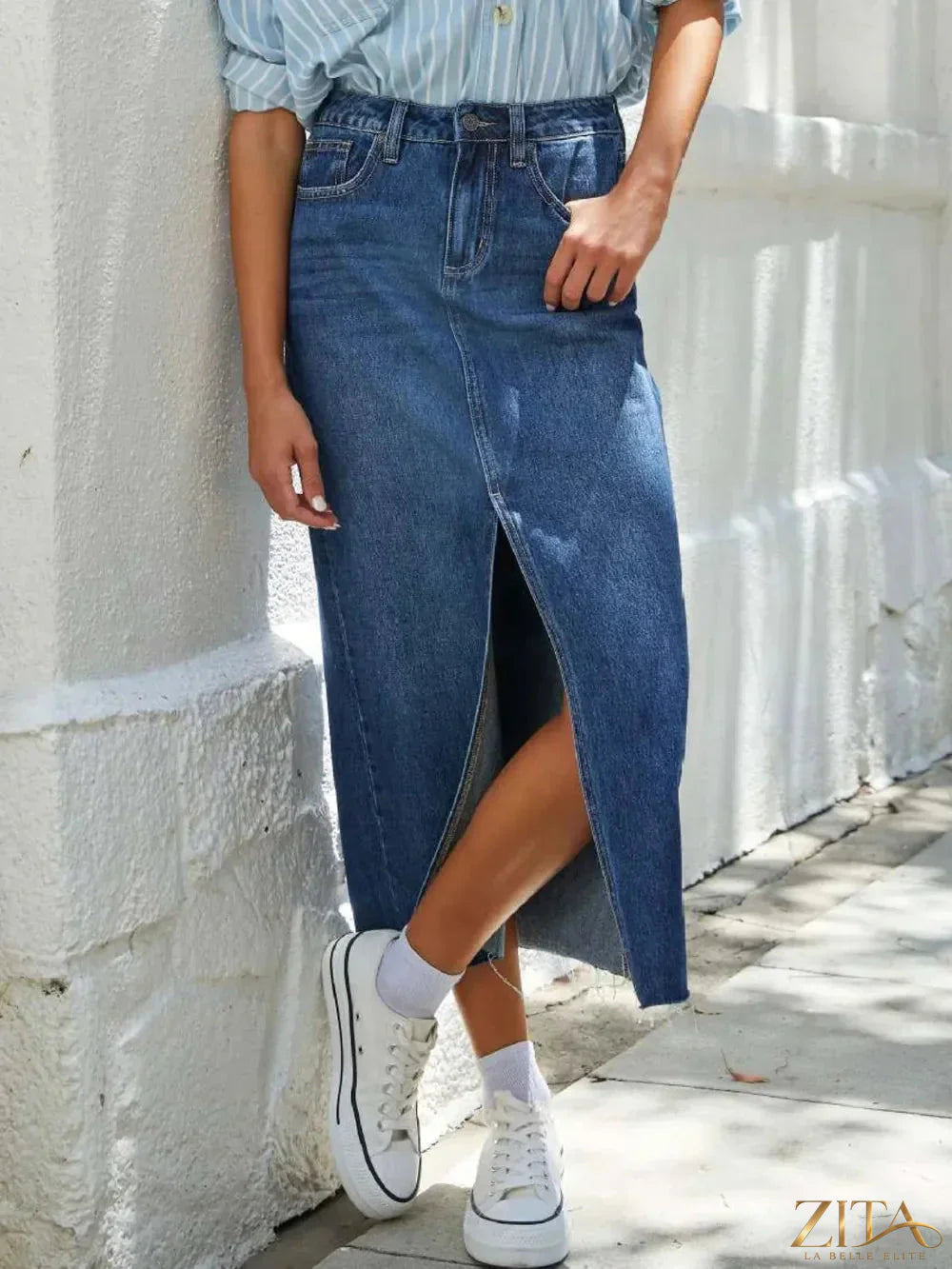 Zita La Belle Elite raw hem front slit denim midi skirt displayed with a high waist and distressed detailing.