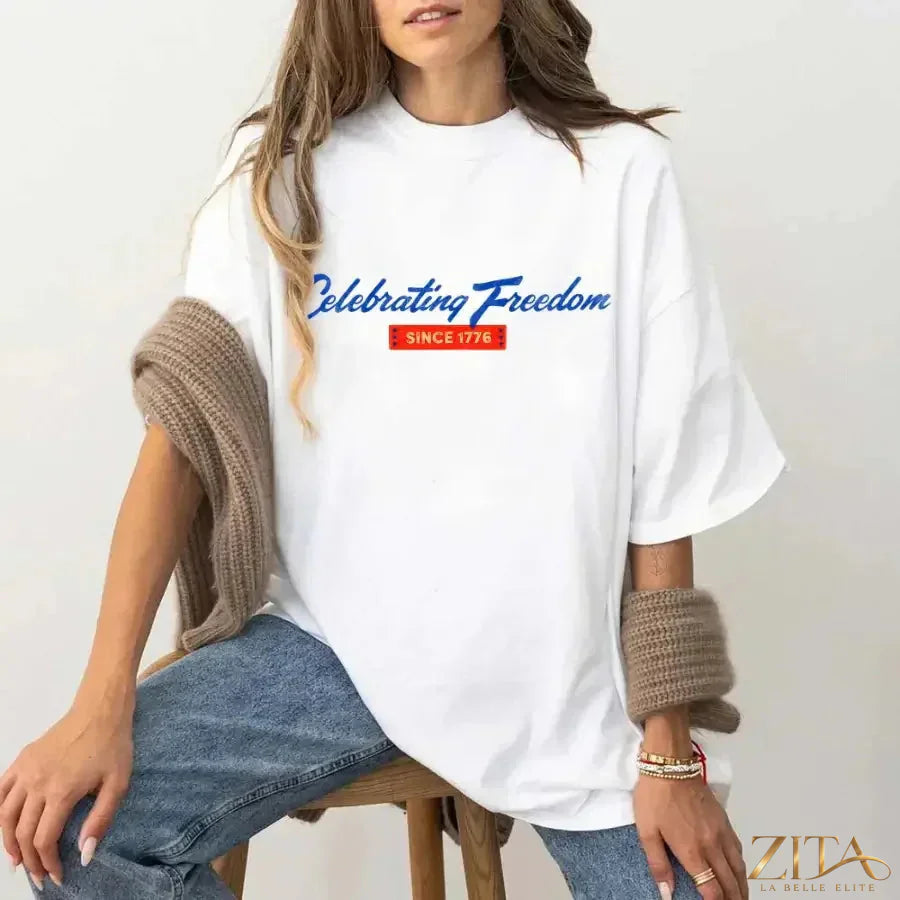 White patriotic T-shirt by Zita La Belle Elite featuring a 4th of July "Celebrating Freedom Since 1776" design.